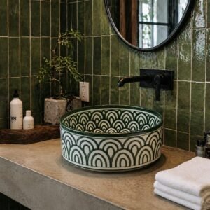 Green ceramic vessel sink installed on luxury bathroom vanity