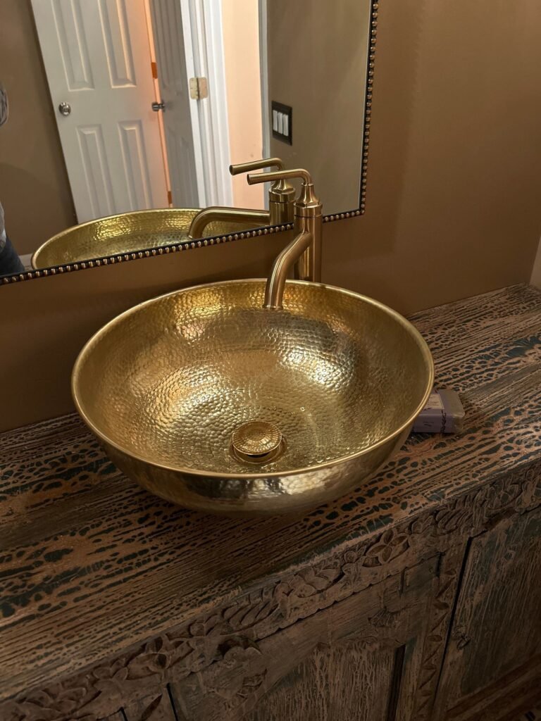 Hammered copper sink installed in a luxury bathroom vanity