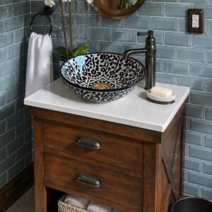 Black and white ceramic vessel sink installed on wooden bathroom vanity